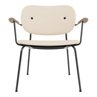 Beige chair with a minimalist design, featuring a cream upholstery and black metal legs. Modern and stylish.