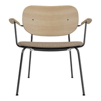 Natural wood finish with a matte beige seat; minimalist design featuring black metal legs and armrests.