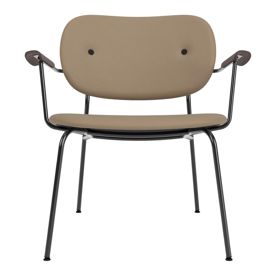 Stylish beige chair with a smooth finish and sleek black metal legs, featuring a minimalist design and rounded edges.