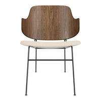 Modern chair featuring a walnut wood back, cream seat, and black metal legs, blending elegance with contemporary design.