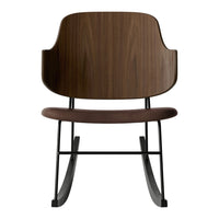 Wooden rocking chair with a rich walnut finish and a sleek black metal base, featuring a minimalist design.