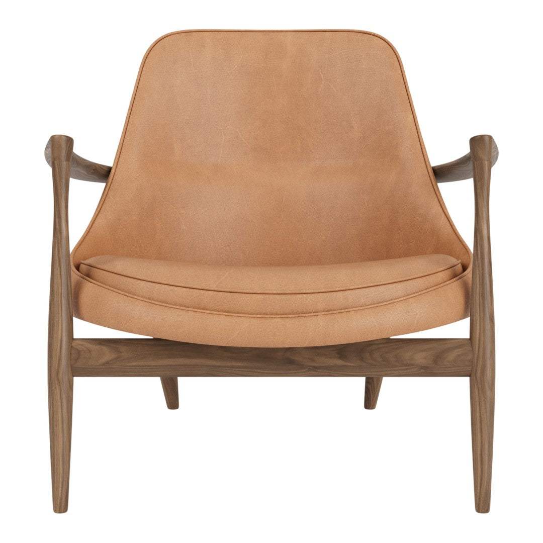 Light tan leather armchair with smooth texture and natural wood accents, featuring a modern, minimalist design.