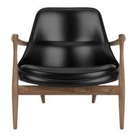Black modern armchair with a sleek, curved seat and natural wood legs. Perfect blend of elegance and comfort.