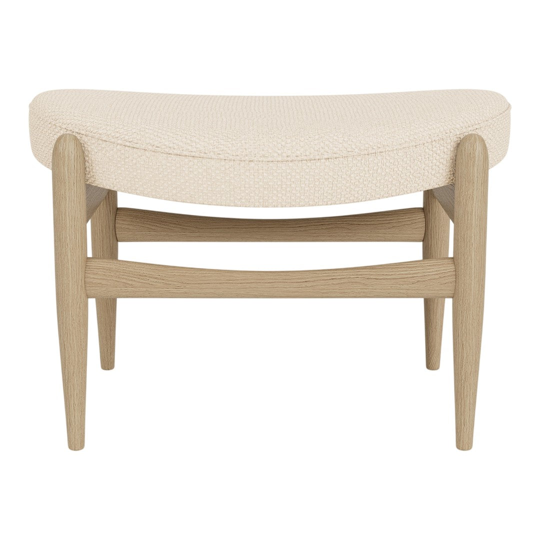 Cream upholstered bench with a curved design and light wooden legs, featuring a smooth, textured pattern.