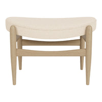 Cream upholstered bench with a curved design and light wooden legs, featuring a smooth, textured pattern.