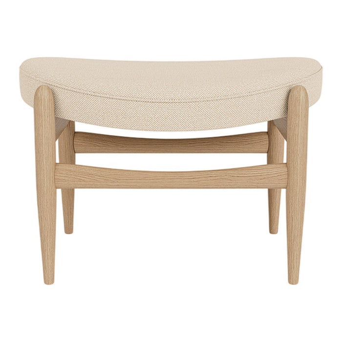 Beige upholstered stool with a curved design and light wood frame, featuring a minimalist style and clean lines.