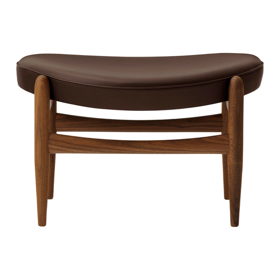 Brown leather cushioned bench with a curved shape and wooden legs, featuring a minimalist design.