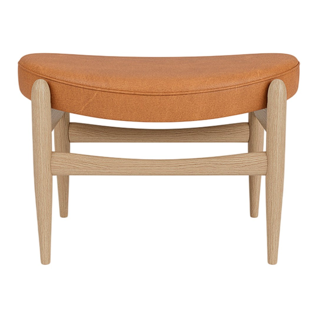 Orange upholstered bench with a curved design and light wood legs, showcasing a modern, minimalistic style.