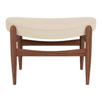 Cream upholstered bench with a curved top, featuring rich brown wooden legs and a smooth finish.