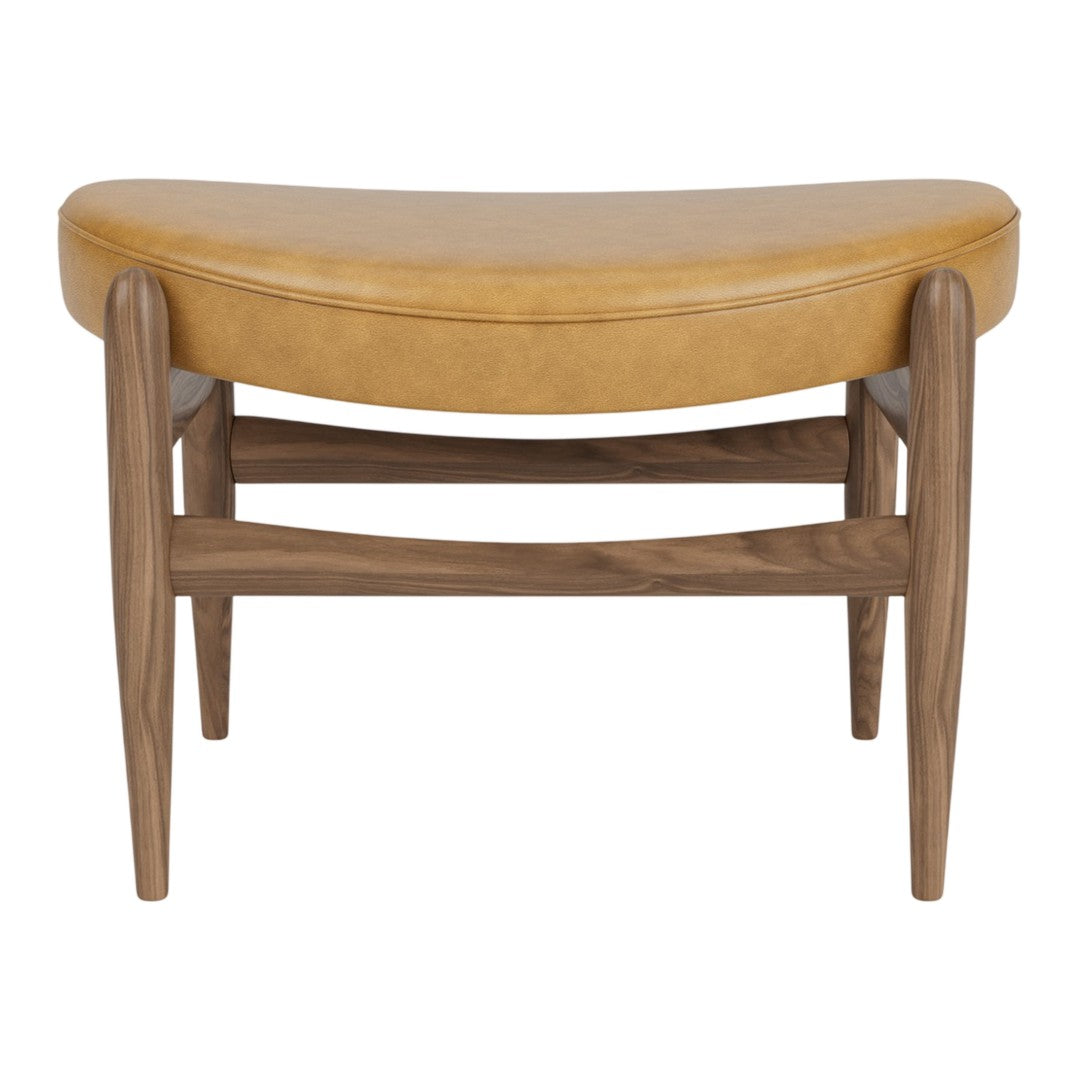 "Tan leather bench with a curved seat and walnut legs, showcasing a sleek, modern design."