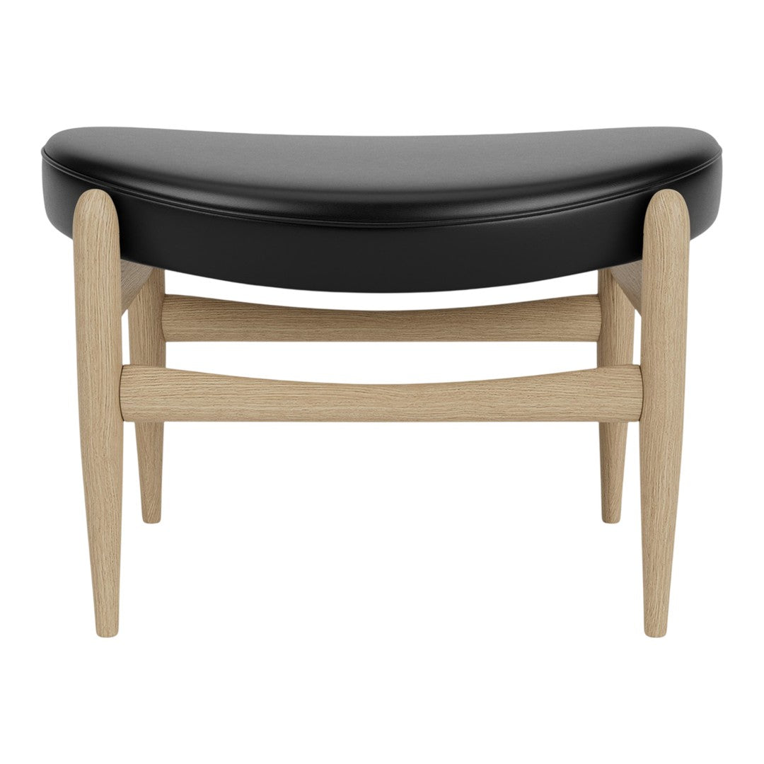 Black curved cushion with light wood legs, featuring a minimalist design for modern decor.