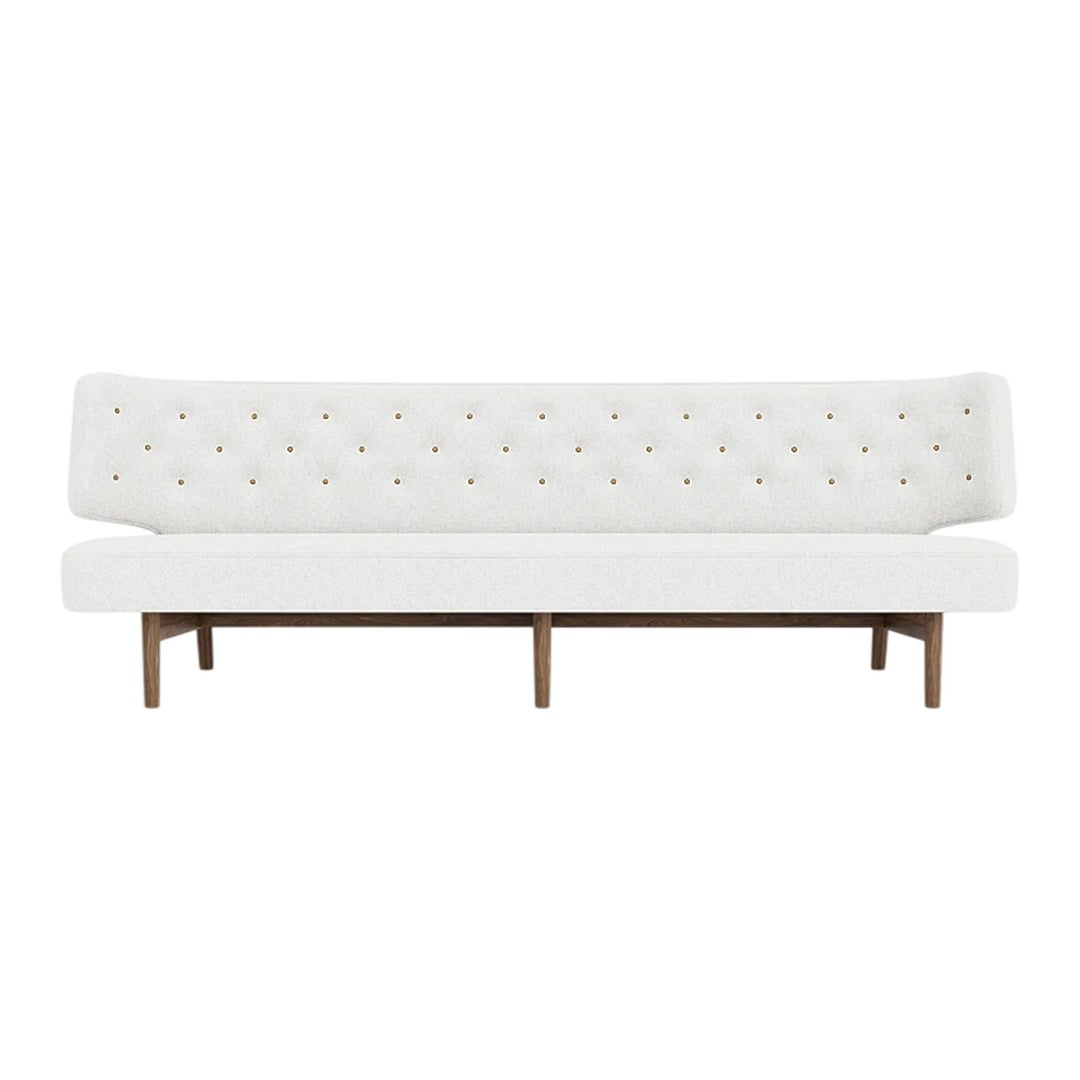 White tufted sofa with colorful button accents and a wooden frame, perfect for modern decor.