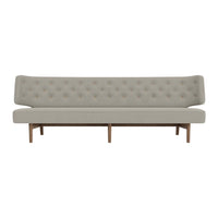Light gray tufted sofa with a clean design and natural wood legs, featuring a minimalist aesthetic.