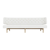 Elegant white tufted sofa with colorful button accents and natural wood legs, perfect for modern living spaces.
