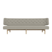 Light gray tufted sofa with a sleek design and natural wood legs, ideal for modern living spaces.