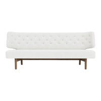 Elegant white sofa with tufted upholstery and wooden legs, perfect for modern decor.