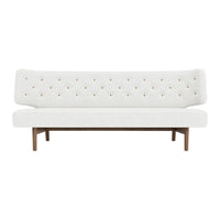 White tufted sofa with gold button accents and a wooden base, featuring a clean, minimalist design.