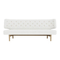 White tufted sofa with minimalistic design and subtle beige wooden legs, featuring a simple, elegant aesthetic.