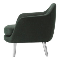 Green upholstered chair with a smooth finish and sleek silver legs, showcasing a modern and minimalist design.