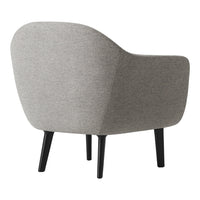 Cozy gray upholstered chair with smooth curves and black wooden legs, perfect for modern interiors.