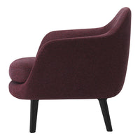 Curved burgundy chair with a textured fabric and sleek black legs, showcasing modern elegance and cozy design.