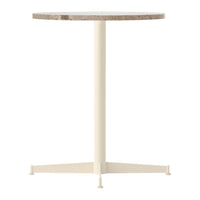 Round table with a beige and gray marble top and a cream-colored metal base, showcasing a modern minimalist design.