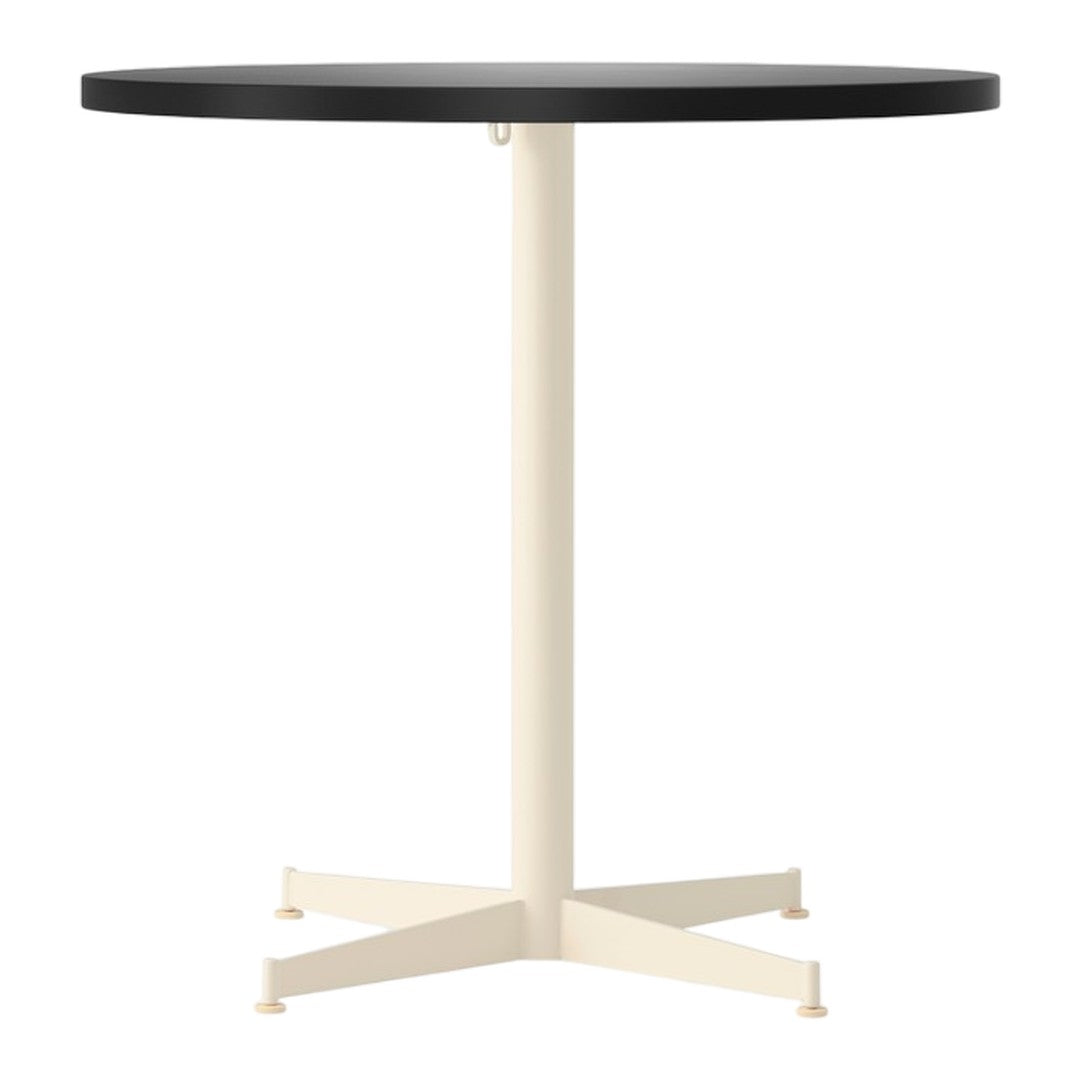 Round table with a sleek black top and a contrasting cream-colored base. Modern design for any space.