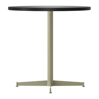 Modern round table with a black top and a light olive green metal base. Clean, minimalist design.