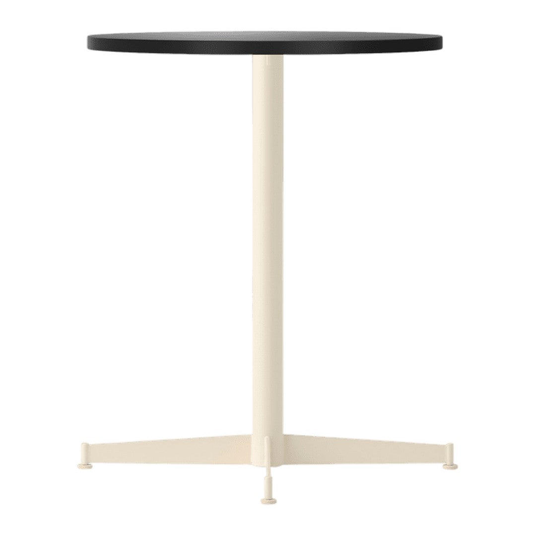 Round black tabletop with a cream-colored base in a minimalist design. Perfect for modern decor.