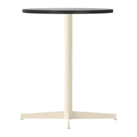Black round tabletop with a cream-colored base and tripod legs, showcasing a sleek and modern design.