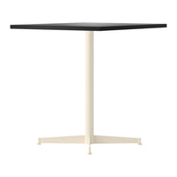 Square table with a sleek black top and a creamy beige base, featuring a minimalist design and clean lines.