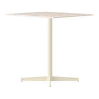 Square dining table in a soft cream color with a minimalist design and smooth surface. Perfect for modern decor.