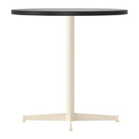 Round table with a black top and cream-colored base, featuring a simple, modern design. Perfect for contemporary spaces.
