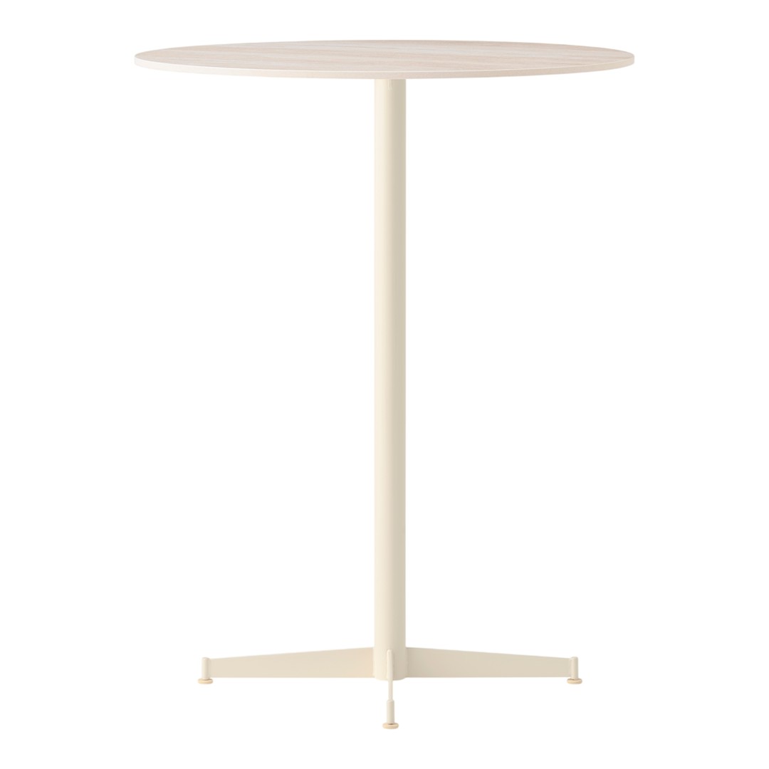 Cream-colored round table with a simple, smooth surface and a sleek metal base. Modern minimalist style.