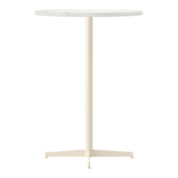 Round white tabletop with a smooth surface and a light cream-colored three-legged base. Modern and minimalist design.