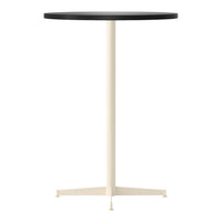 Round black tabletop with a sleek cream-colored base, featuring a minimalist design ideal for modern spaces.