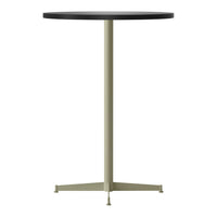Black round table top with a sleek light green metal base and minimalist design. Ideal for modern decor.