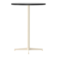 Round table with a sleek black top and a light cream-colored base. Perfect for modern decor.