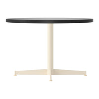 Round table featuring a sleek black top and a contrasting cream-colored base. Minimalist and modern design.