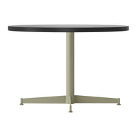 Black round tabletop with a minimalist light green metal base. Clean, modern design suitable for any decor.