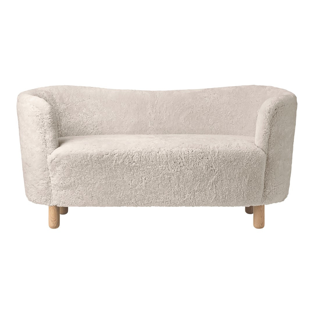 Soft, plush cream-colored sofa with rounded edges and wooden legs, perfect for modern, cozy interiors.