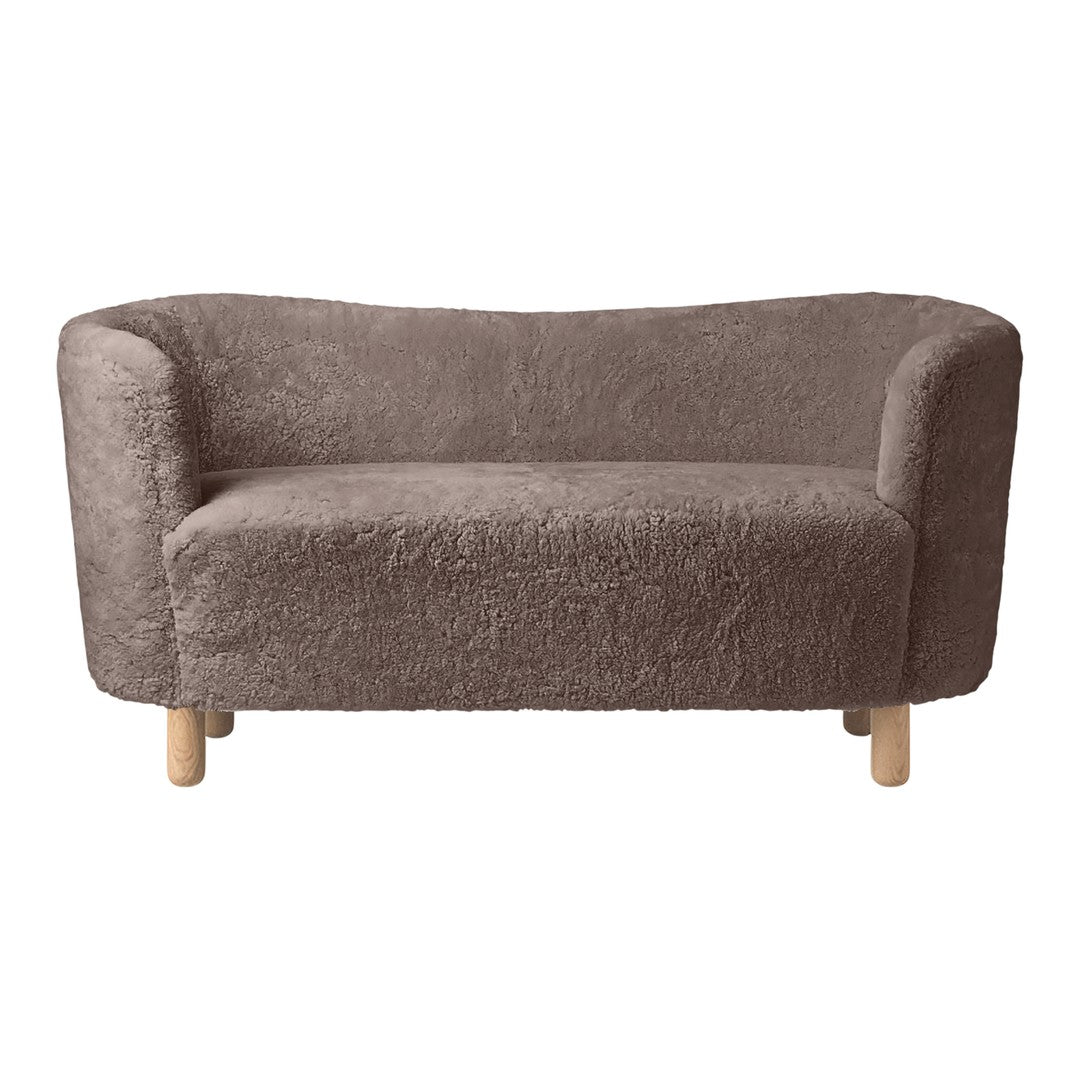 Soft brown plush sofa with curved edges and natural wooden legs, featuring a cozy, textured fabric.