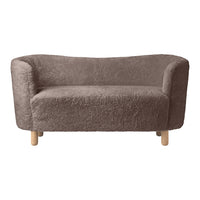 Soft brown plush sofa with curved edges and natural wooden legs, featuring a cozy, textured fabric.
