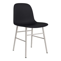 Modern black chair with smooth finish and sleek silver legs, perfect for minimalist decor.