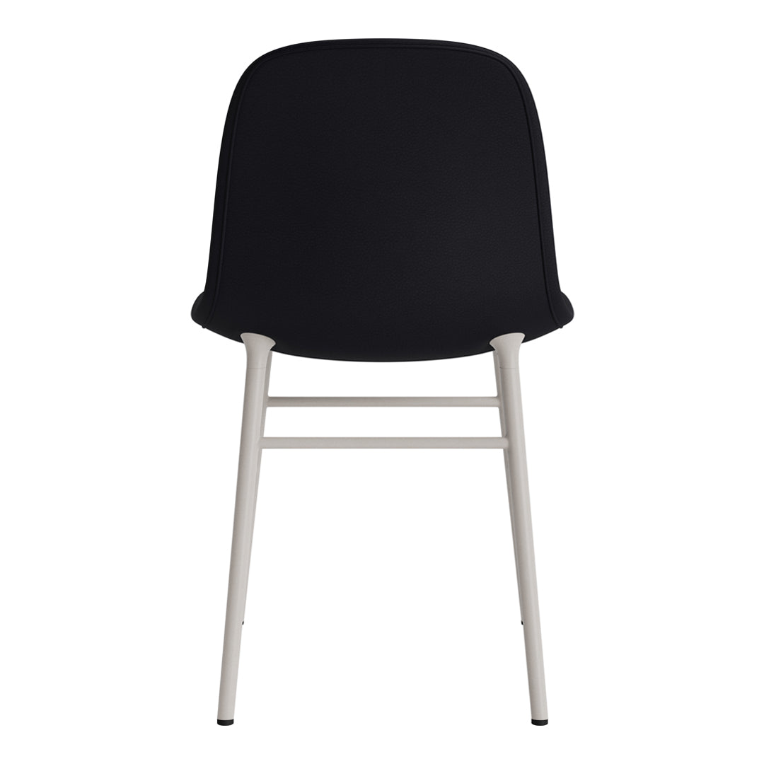 Black upholstered dining chair with sleek white metal legs, minimalist design and smooth, modern finish.