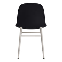 Black upholstered dining chair with sleek white metal legs, minimalist design and smooth, modern finish.