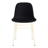 Black plastic chair with a smooth, modern design and light wooden legs. Minimalist style for contemporary spaces.