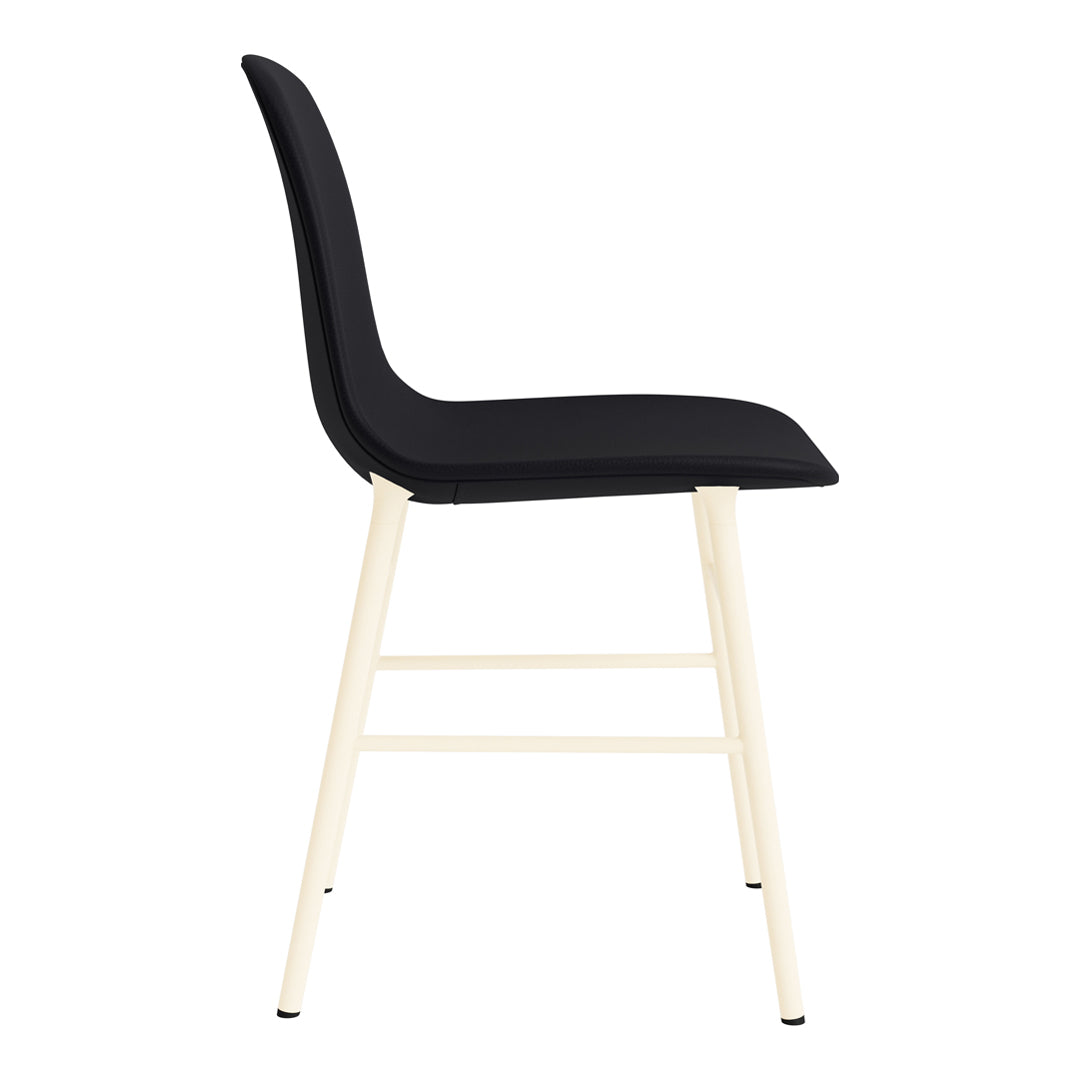 Black upholstered chair with a smooth texture and light beige wooden legs. Stylish and modern design.