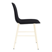 Black upholstered chair with a smooth texture and light beige wooden legs. Stylish and modern design.