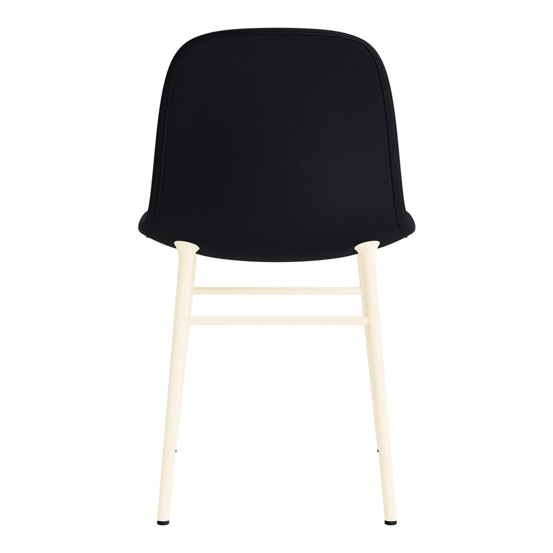 Black chair with a smooth surface and contrasting light wood legs, showcasing a modern and minimalist design.